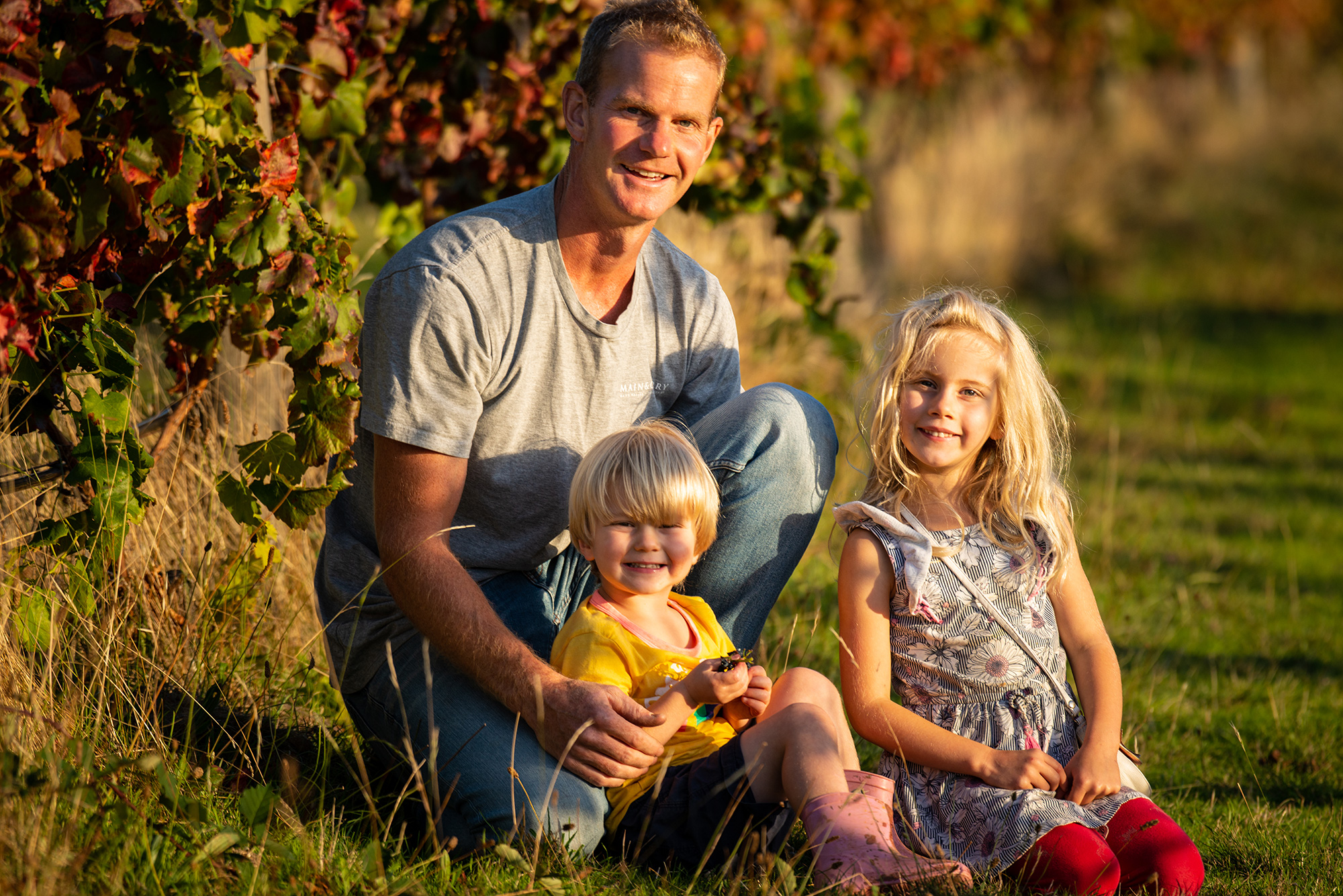 Owner and winemaker Michael Sexton with his two children among the vineyard.